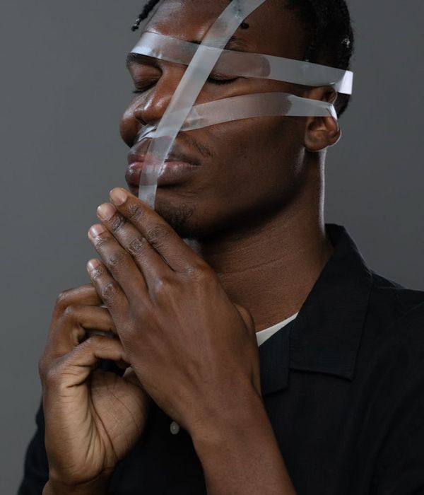 Close-up of a person's hands in a meditative gesture.